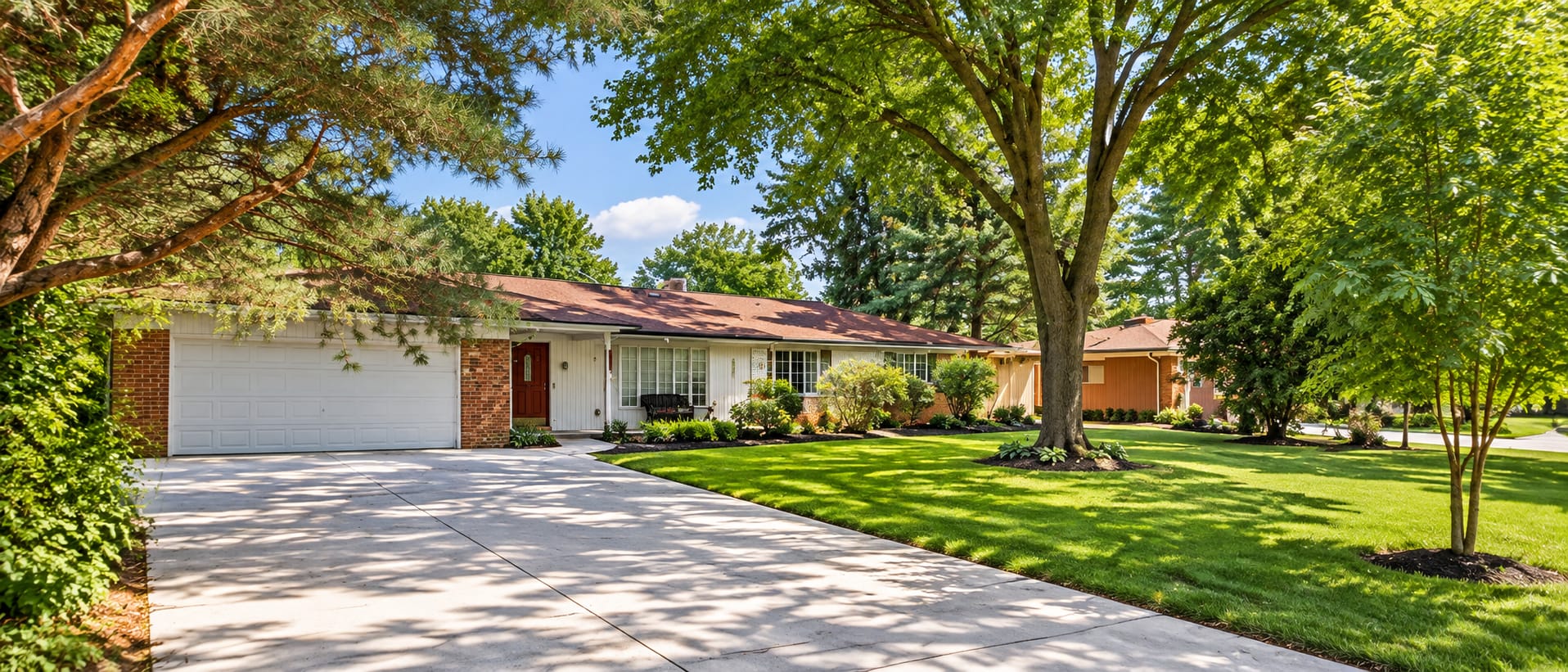 The Sherwood Shul building, a ranch-style house with a wide lawn and tall trees